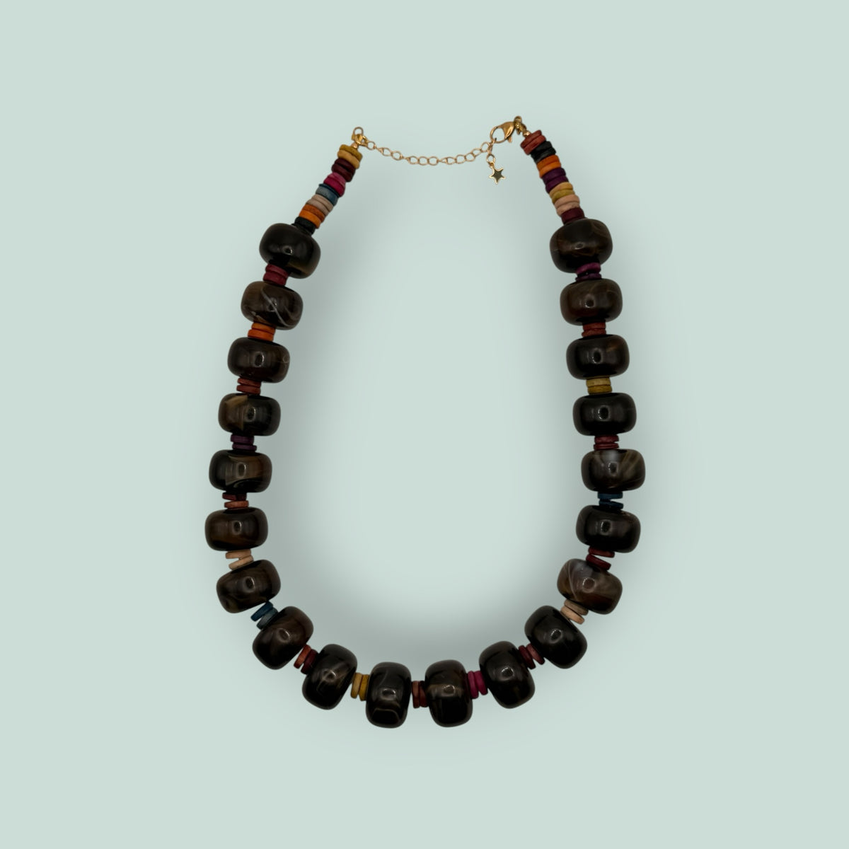 The Salty Bead Co handcrafted statement necklace featuring polished dark brown agate beads and colorful spacer accents.