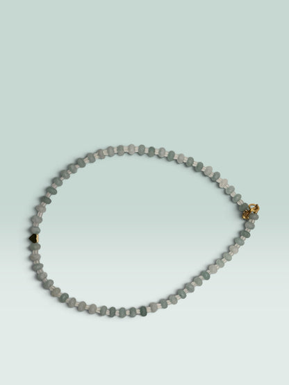 The Salty Bead Co beaded necklace with aquamarine-toned faceted beads, clear spacers, and a gold-tone heart charm.