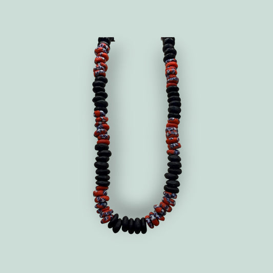 The Salty Bead Co handcrafted necklace with matte black disc beads and patterned red and blue glass accent beads