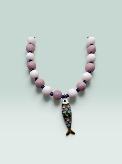 The Salty Bead Co handcrafted necklace with mauve and pink matte beads, blue spacers, and a colorful enamel fish charm