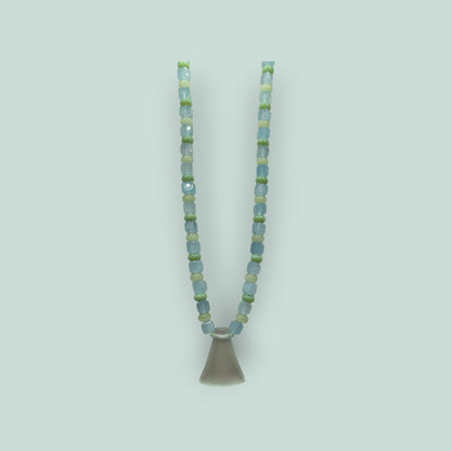 The Salty Bead Co handcrafted necklace with light blue and sage green glass beads and a frosted flared glass pendant.