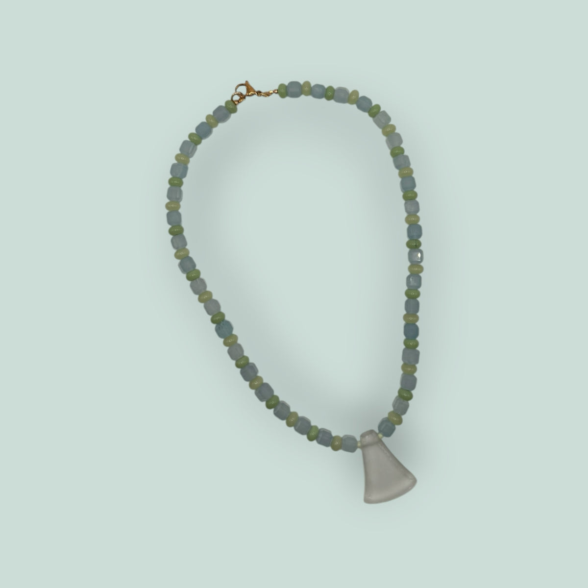 The Salty Bead Co handcrafted necklace with light blue and sage green glass beads and a frosted flared pendant.