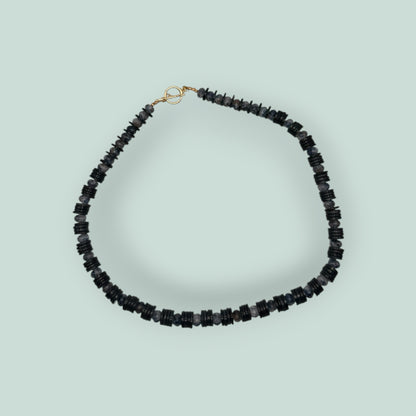 The Salty Bead Co handcrafted necklace with alternating black disc beads and mottled grey stone beads, gold toggle clasp