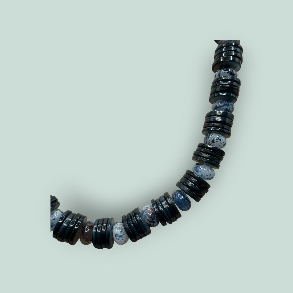 The Salty Bead Co handcrafted necklace with alternating polished black disc beads and mottled grey stone beads.