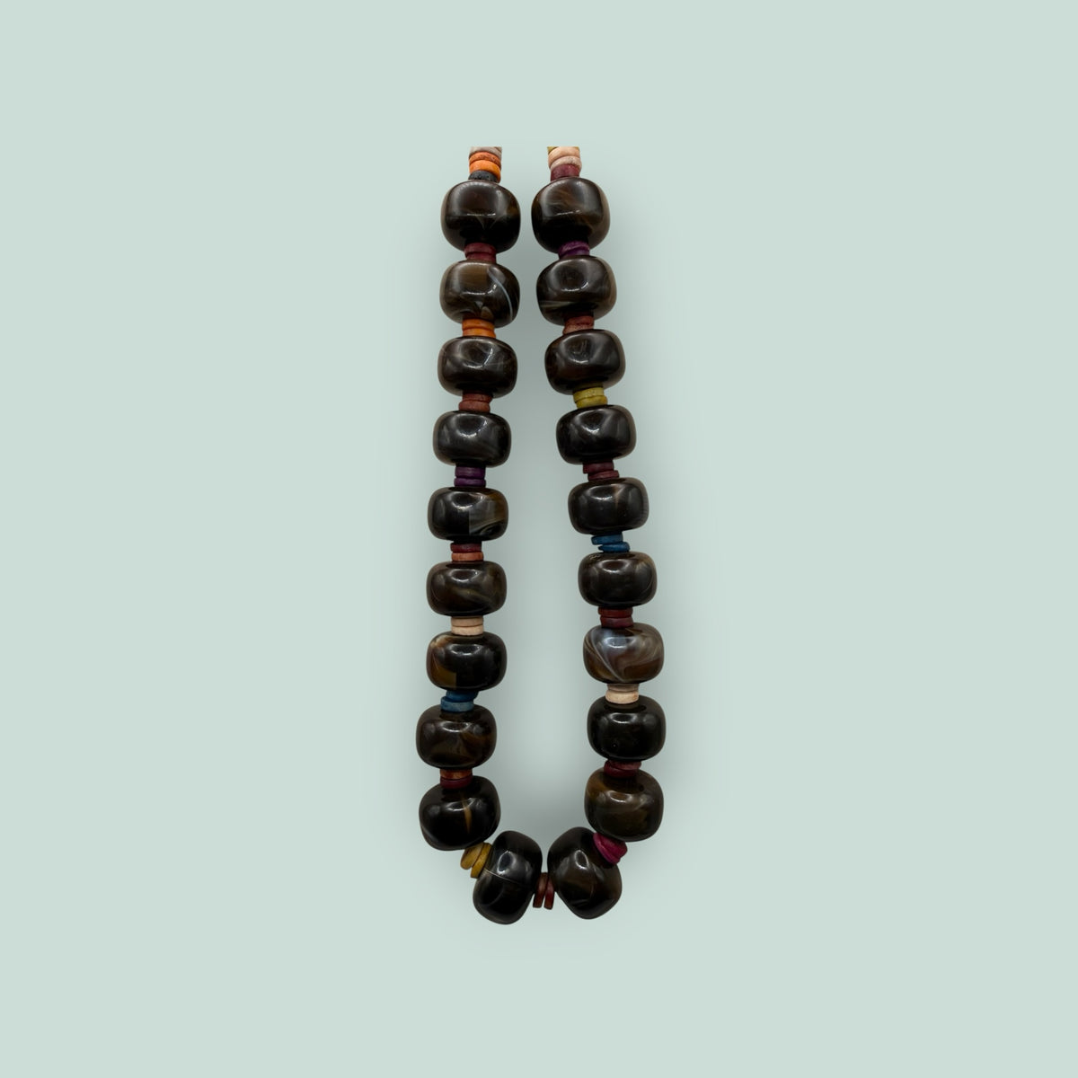 The Salty Bead Co handcrafted statement necklace featuring polished dark brown agate beads with colorful spacers.