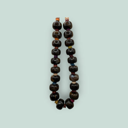 The Salty Bead Co handcrafted statement necklace featuring polished dark brown agate beads with colorful spacers.