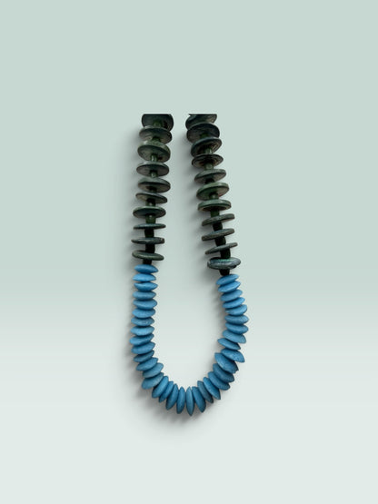 The Salty Bead Co handcrafted statement necklace featuring forest green and sky blue flattened disc beads.