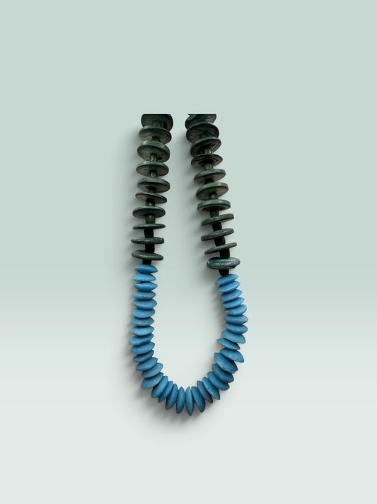 The Salty Bead Co handcrafted statement necklace featuring forest green and sky blue flattened disc beads.