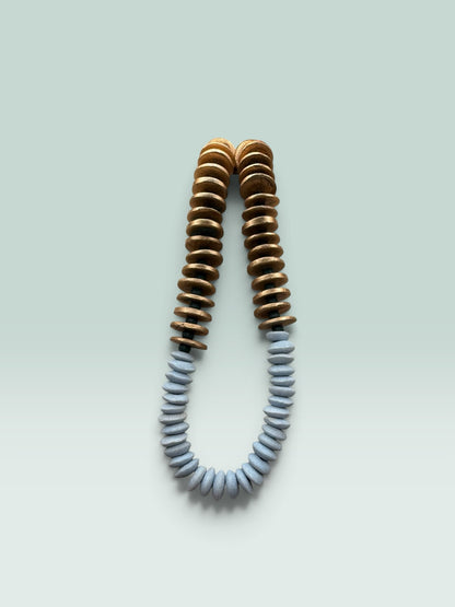 The Salty Bead Co handcrafted statement necklace featuring gold-toned and slate-grey flattened disc beads.