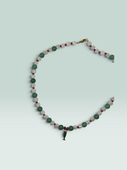 The Salty Bead Co beaded necklace with green aventurine, white quartz, red accents, and a green enamel fish pendant.