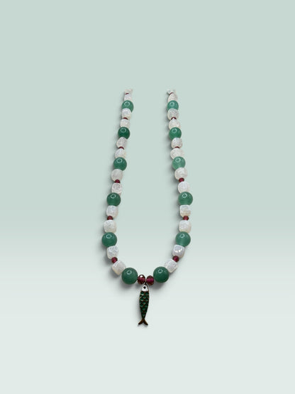 The Salty Bead Co beaded necklace with green aventurine, white quartz, red accents, and a green enamel fish pendant.