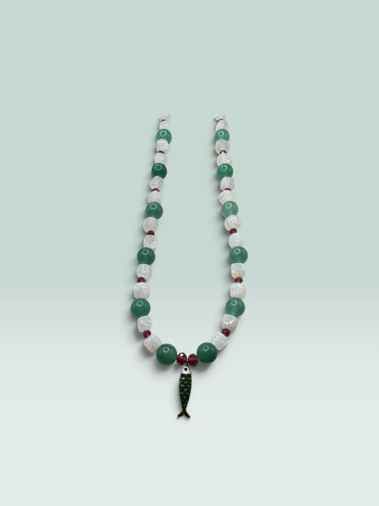 The Salty Bead Co beaded necklace with green aventurine, white quartz, red accents, and a green enamel fish pendant.