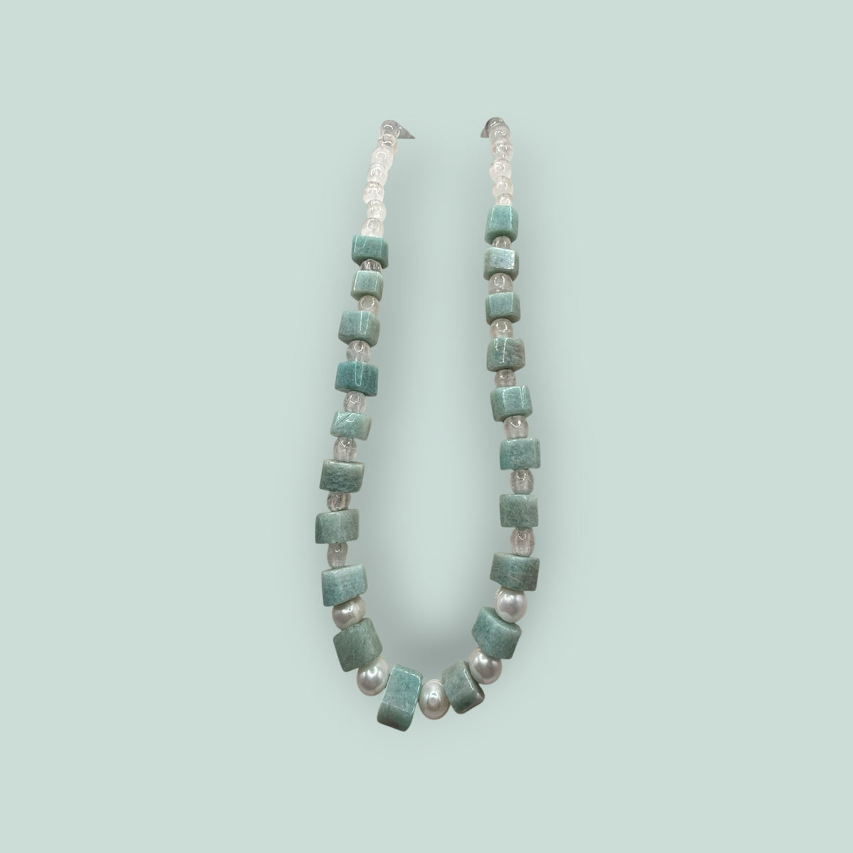 The Salty Bead Co handcrafted statement necklace featuring cube-cut green gemstones and lustrous freshwater pearls.
