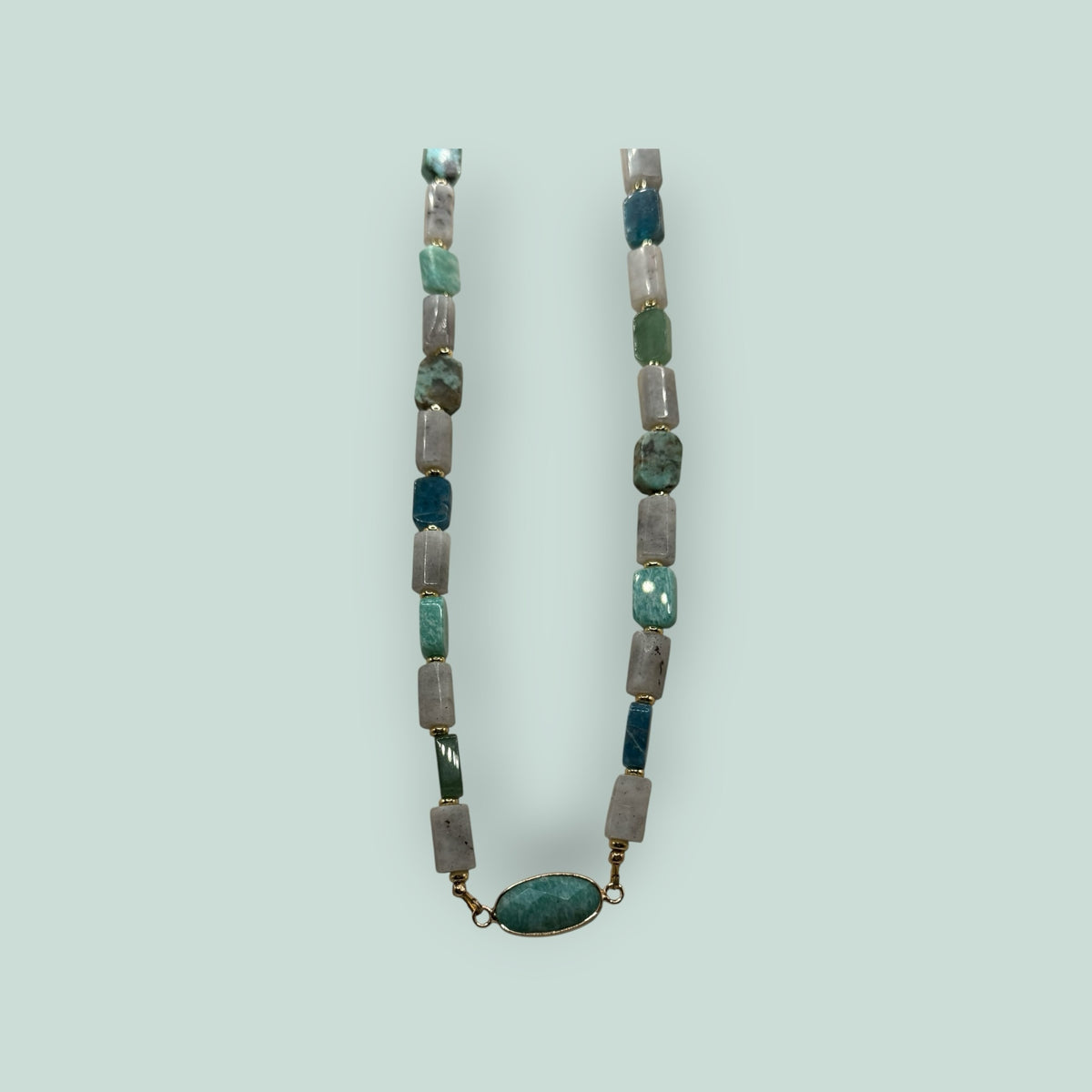 The Salty Bead Co handcrafted necklace with sage, forest green, and grey rectangular stones and oval statement pendant.