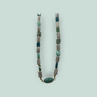 The Salty Bead Co handcrafted necklace with sage, forest green, and grey rectangular stones and oval statement pendant.