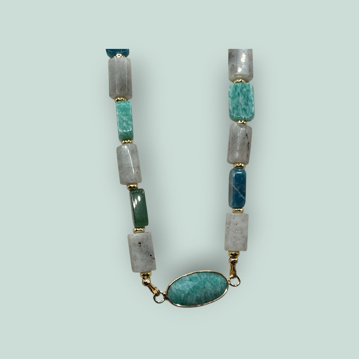 The Salty Bead Co handcrafted gemstone necklace with rectangular sage, green, and grey stones and an oval pendant.