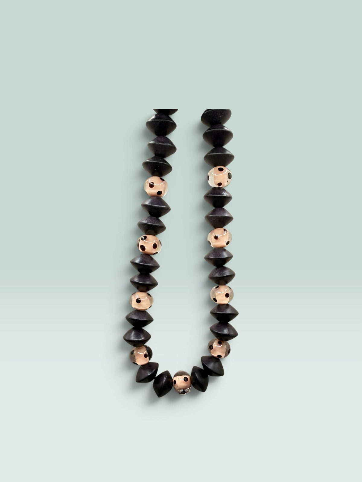 The Salty Bead Co handcrafted statement necklace with matte black geometric and blush polka dot beads.