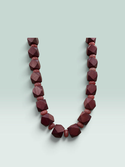 The Salty Bead Co geometric wooden necklace featuring faceted dark mahogany and smooth dusty rose beads.