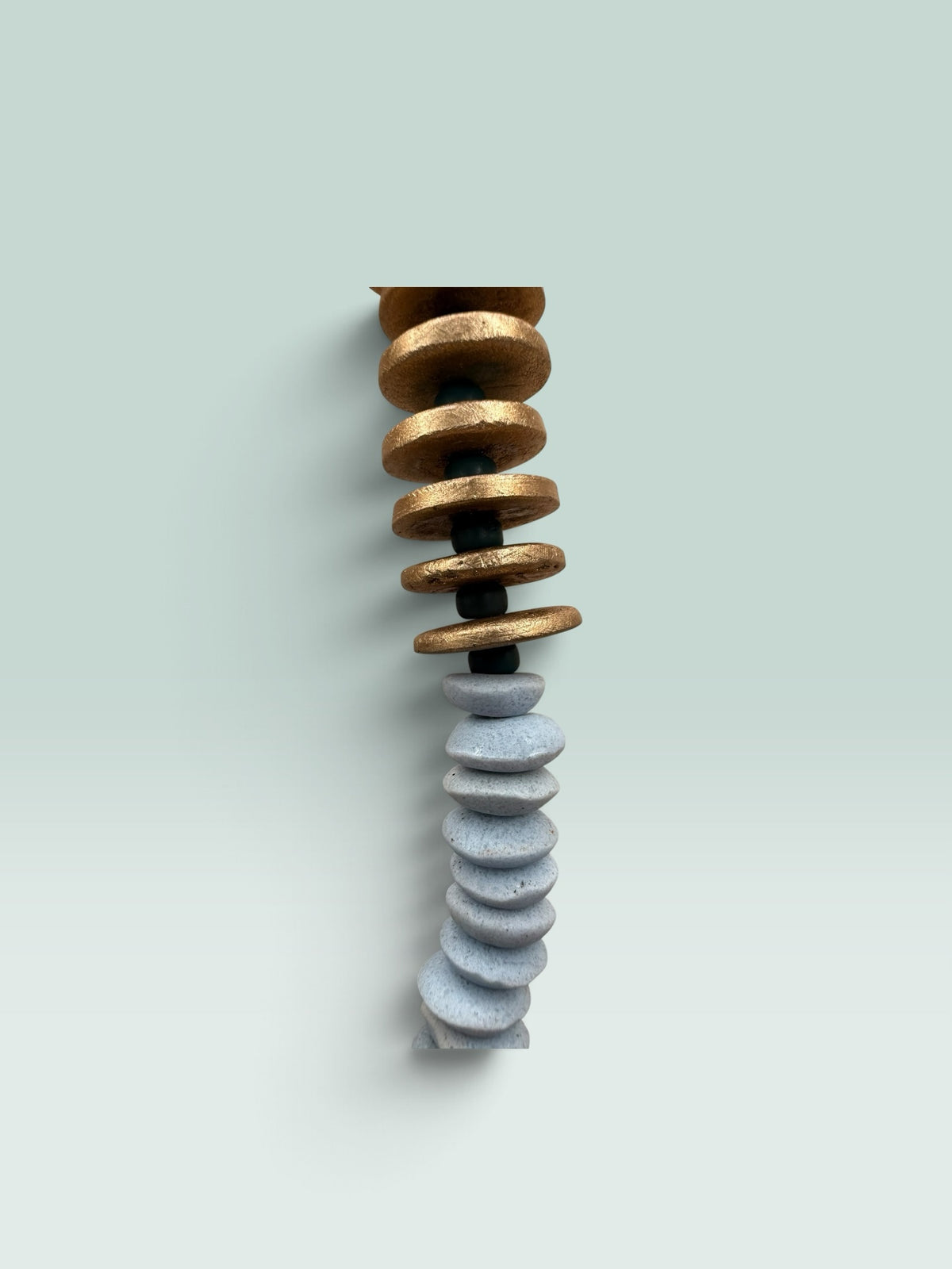 The Salty Bead Co handcrafted statement necklace featuring gold-toned and slate-grey flattened disc beads.