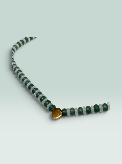 The Salty Bead Co statement necklace with alternating forest green and translucent grey beads and a gold-tone charm.