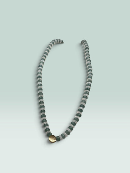 The Salty Bead Co beaded statement necklace with forest green and translucent grey beads and a gold-tone central charm.