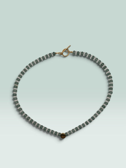 The Salty Bead Co beaded statement necklace with forest green and translucent grey beads and a gold-tone toggle clasp.