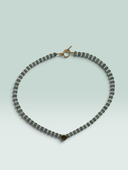 The Salty Bead Co beaded statement necklace with forest green and translucent grey beads and a gold-tone toggle clasp.