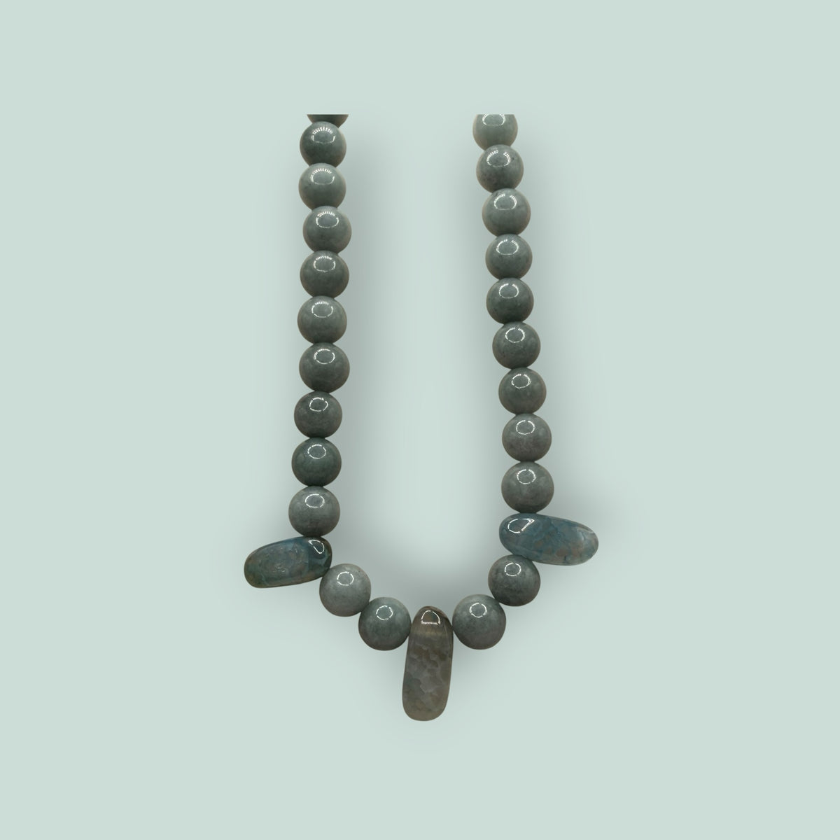 The Salty Bead Co handcrafted grey stone beaded necklace with elongated accent stones and a minimalist design.