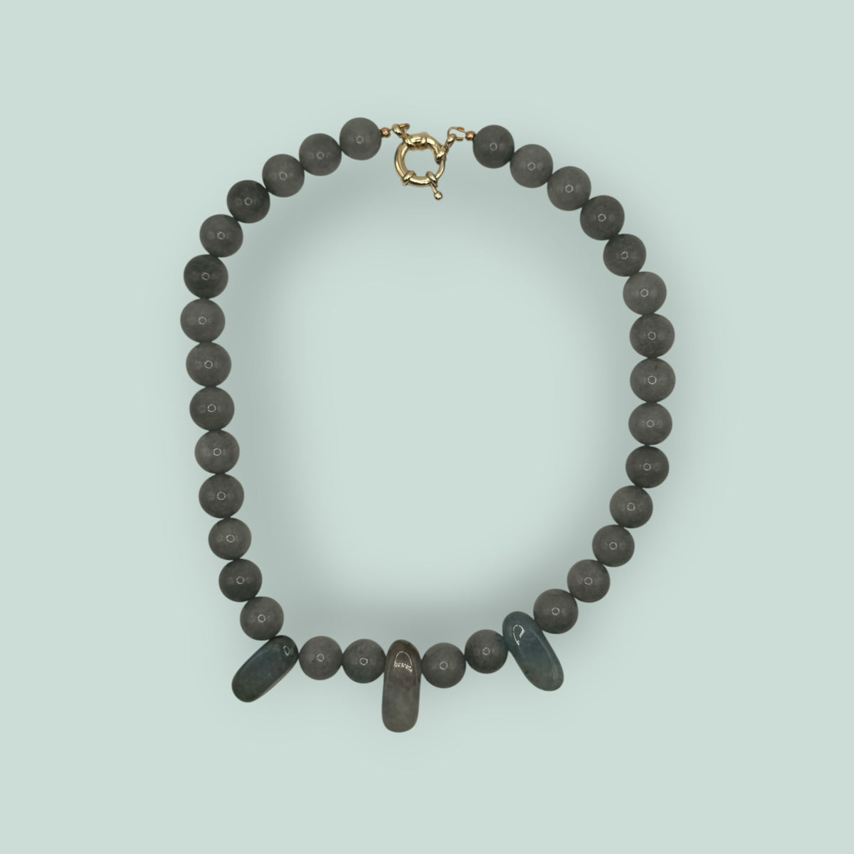 The Salty Bead Co handcrafted grey stone beaded necklace with elongated accent beads and a gold-tone clasp
