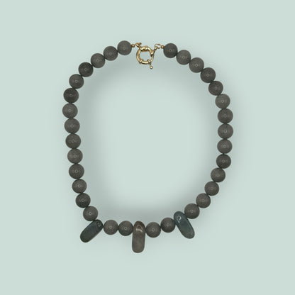 The Salty Bead Co handcrafted grey stone beaded necklace with elongated accent beads and a gold-tone clasp