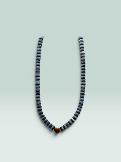 The Salty Bead Co beaded necklace with alternating grey and charcoal disc beads and a polished gold-tone heart charm.
