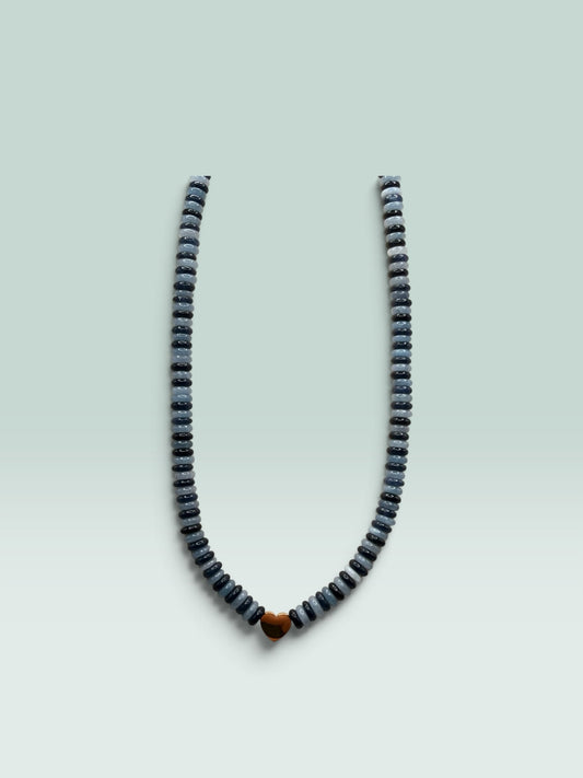 The Salty Bead Co beaded necklace with alternating grey and charcoal disc beads and a polished gold-tone heart charm.