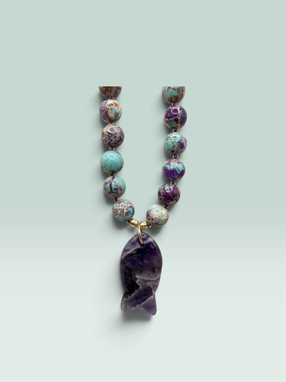 The Salty Bead Co handcrafted necklace with marbled jasper beads in green and purple and a polished amethyst fish pendant