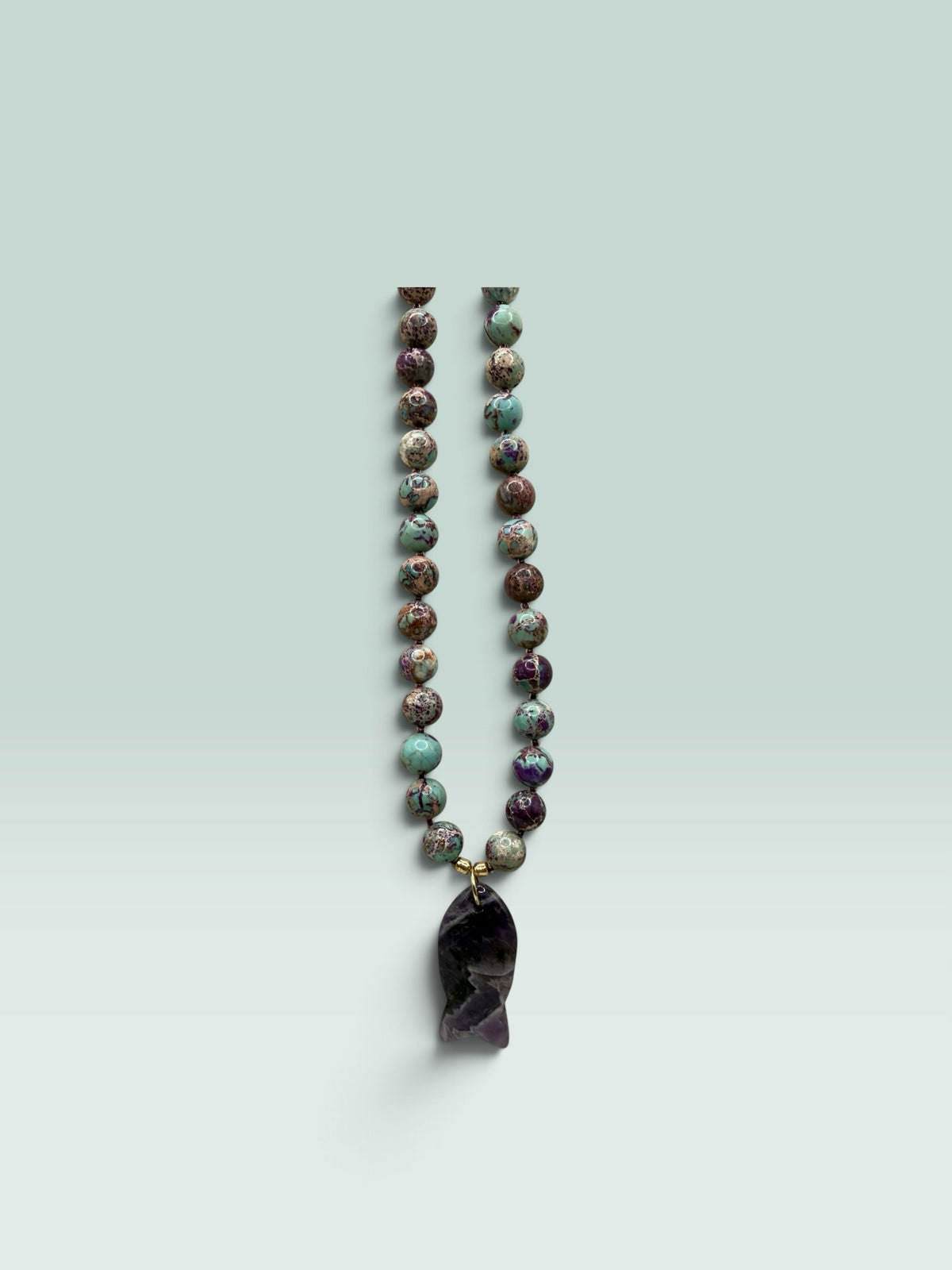 The Salty Bead Co handcrafted necklace with marbled jasper beads and a polished amethyst fish pendant.