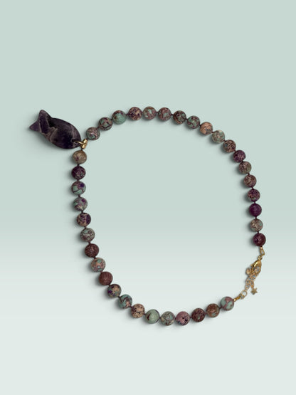 The Salty Bead Co handcrafted necklace with marbled jasper beads in green and purple and a fish-shaped amethyst pendant
