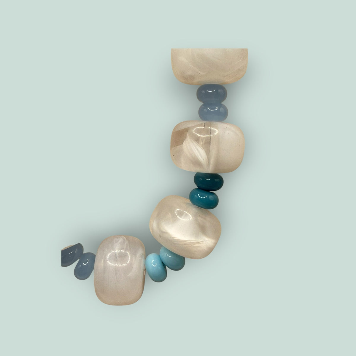 The Salty Bead Co handcrafted statement necklace with marbled cream beads and blue and teal accents
