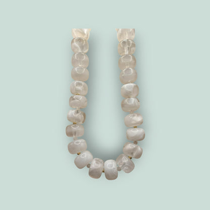 The Salty Bead Co handcrafted statement necklace featuring milky white semi-translucent beads with gold-toned spacers.