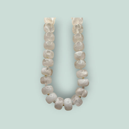 The Salty Bead Co handcrafted statement necklace featuring milky white semi-translucent beads with gold-toned spacers.