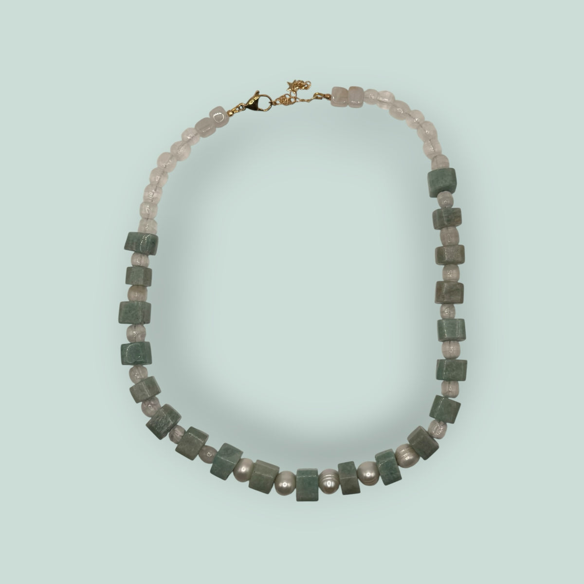 The Salty Bead Co handcrafted necklace featuring freshwater pearls and cube-cut green gemstone beads with gold clasp.