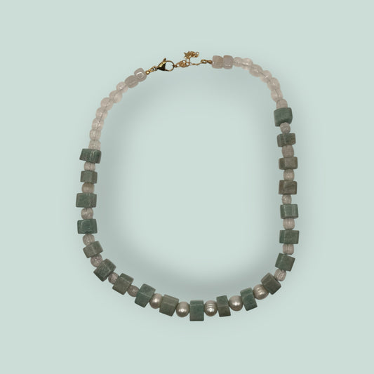 The Salty Bead Co handcrafted necklace featuring freshwater pearls and cube-cut green gemstone beads with gold clasp.
