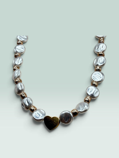 The Salty Bead Co necklace featuring lustrous coin pearls and polished metallic beads with a central gold heart charm.