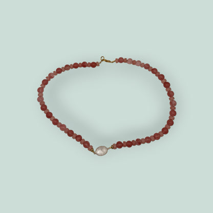 The Salty Bead Co handcrafted necklace with pink and coral beads and a central clear stone pendant