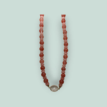 The Salty Bead Co handcrafted necklace with pink and coral beads and a central clear stone pendant