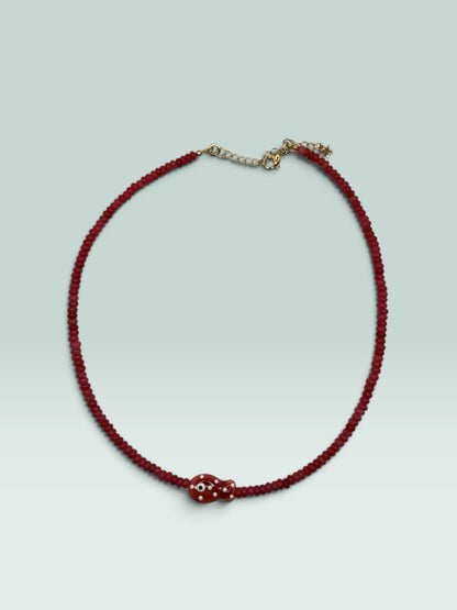 The Salty Bead Co red beaded necklace featuring a whimsical fish pendant with white polka dots and an evil eye detail.