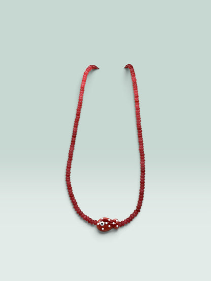 The Salty Bead Co red beaded necklace featuring a whimsical fish pendant with white polka dots and an evil eye detail.
