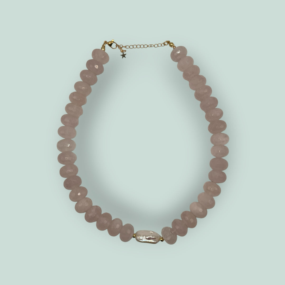 The Salty Bead Co handcrafted necklace with faceted rose quartz beads and a central baroque pearl on gold hardware.