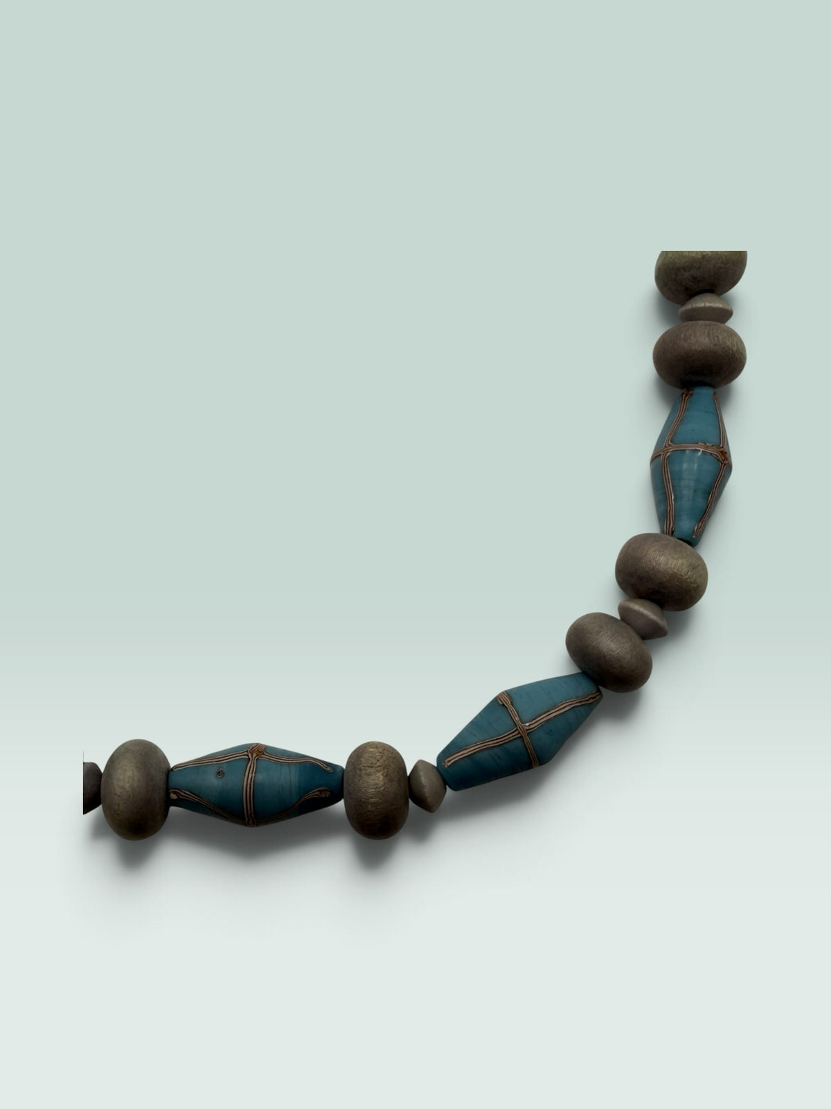 The Salty Bead Co statement necklace featuring matte slate-grey round beads and diamond-shaped teal beads with wire trim