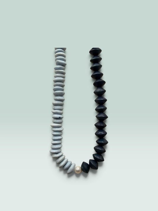 The Salty Bead Co two-tone statement necklace with slate-grey textured beads, matte black beads, and a central pearl.