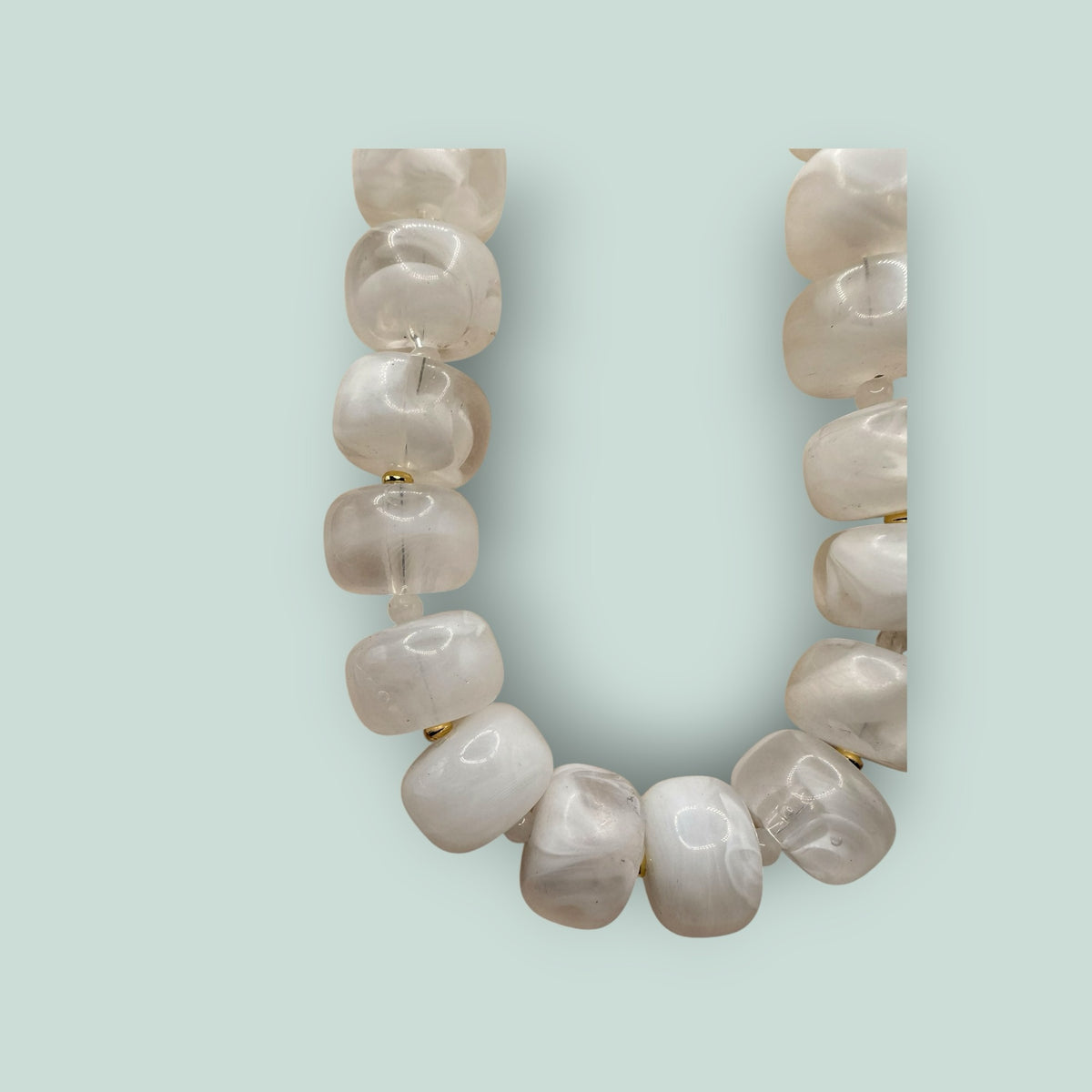 The Salty Bead Co handcrafted statement necklace with milky white semi-translucent beads and gold-toned spacers.